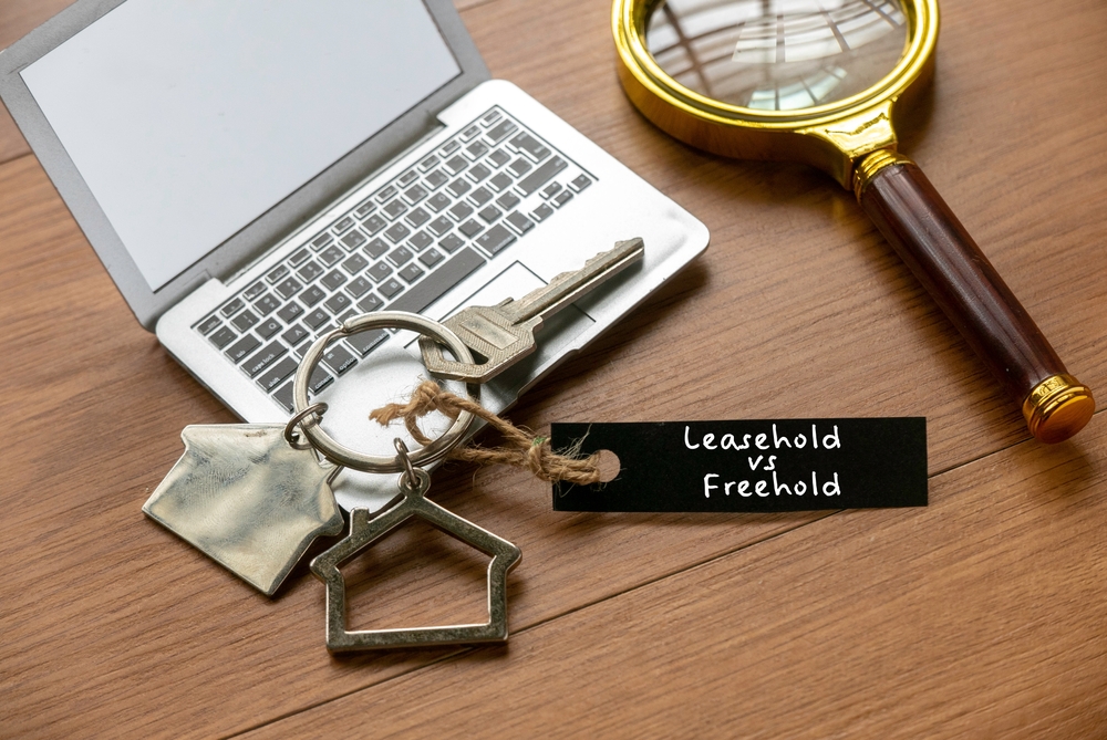 Leasehold and freehold property ownership concept with house keys, illustrating property buying options in Ghana for overseas buyers.